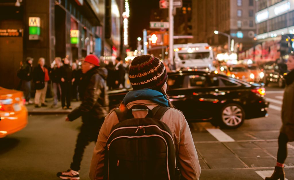 Waiting to cross the road.